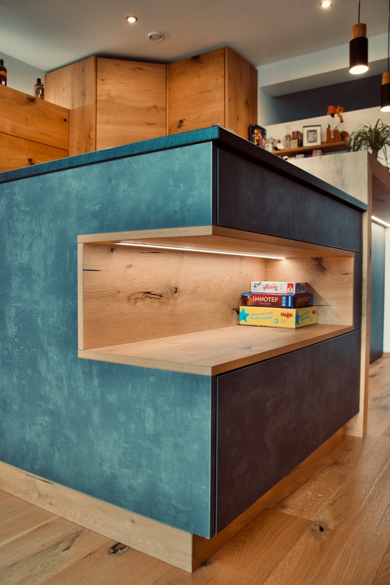 a blue shelf with books on top of it